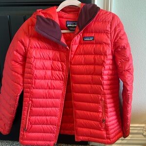 Women’s Patagonia down jacket. Vibrant red ish color. Hooded, great condition.